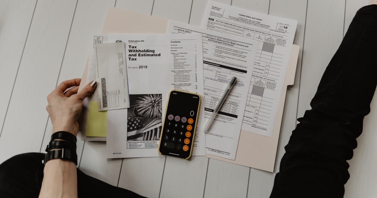 Calculator and documents representing property tax calculations in Spain