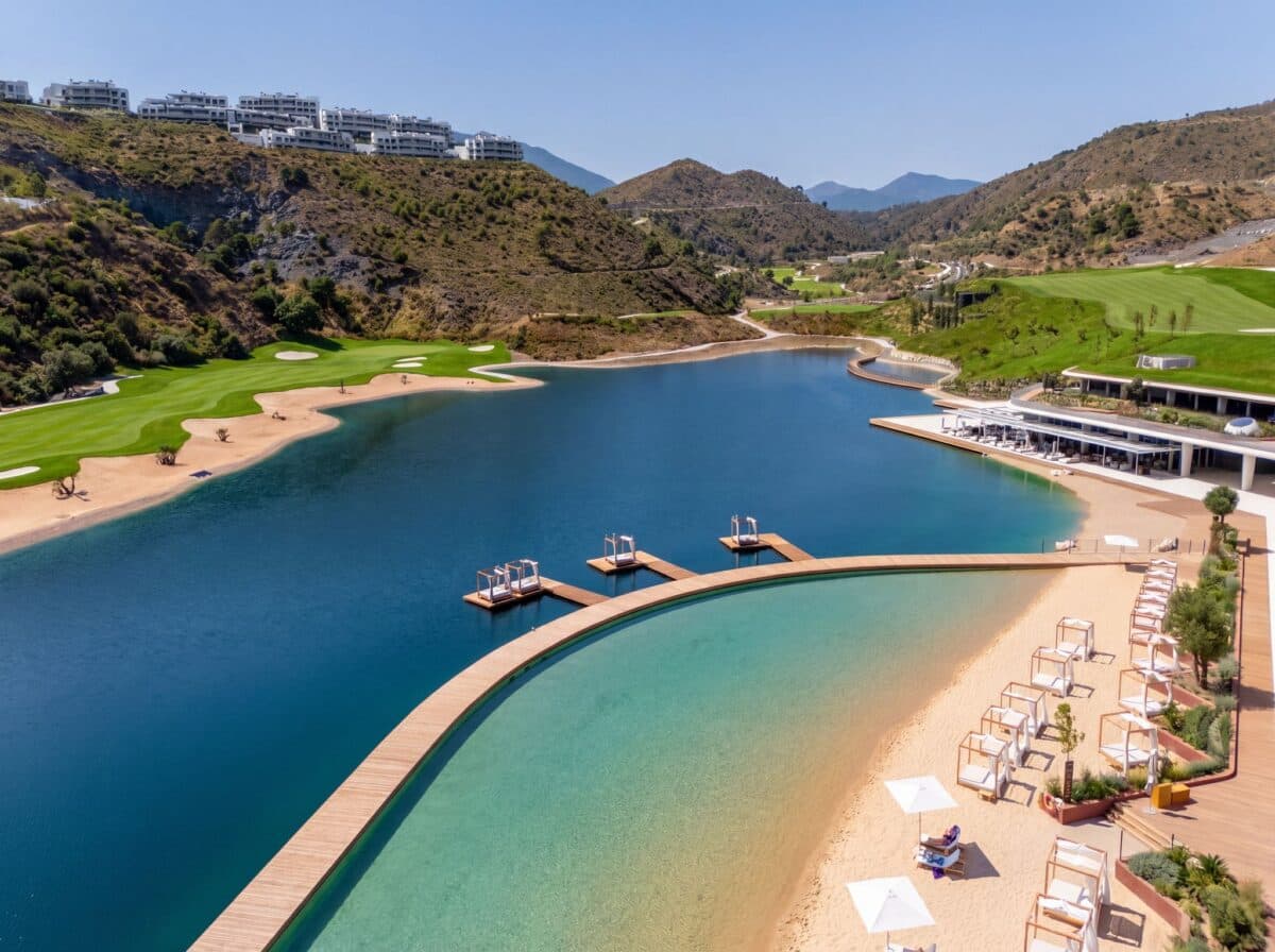 The lake and villas at Real de La Quinta with the Mediterranean beyond